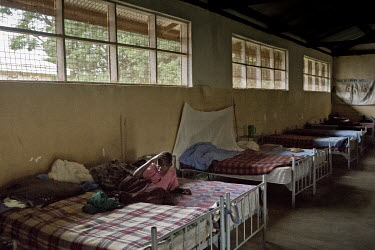 Vicky Aparo (17) rests on her bed in a dormitory for patients affected by Nodding Syndrome in the Kitgum Hospital. The hospital's lack of money, food and medicine explains why the beds are not occupie...