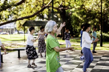 Asian-Australians practice traditional Chinese dancing in a park in Chatswood.