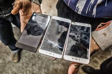 An Afghan refugee shows his smashed mobile phones that he says were destroyed by the Croatian police. The refugees had attempted to cross the Croatian border on foot but were arrested and pushed back...