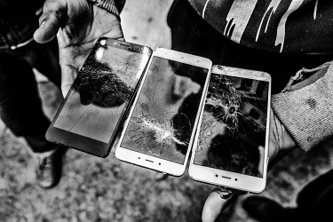 An Afghan refugee shows his smashed mobile phones that he says were destroyed by the Croatian police. The refugees had attempted to cross the Croatian border on foot but were arrested and pushed back...