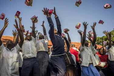 Schoolgirls outside class with sanitary pad kits they were given following a presentation about female reproductive health, a part of activist Dr Stella Nyanzi's 'Pads for Girls'campaign.