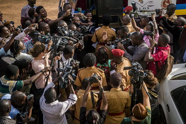 A crowd of reporters surround police and Stella Nyanzi outside the High Court in Kampala as she enters a bus bound for Luzira prison. She had been jailed in relation to a case of 'cyber-harassment' of...