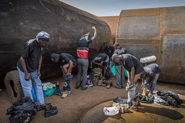Stuntmen getting changed for a shoot in an old metal workshop for an action sequence for the movie 'Kakongoliro operationÂ� (Very Dangerous Operation), - the Â�Ugandan Expendables'. Wakaliga slums,...