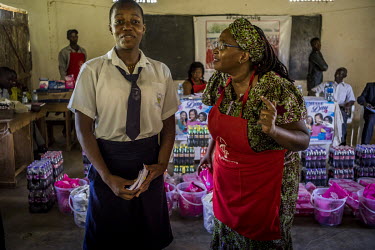 Dr Stella Nyanzi talks to a teenager about sanitary pads during a school visit.
