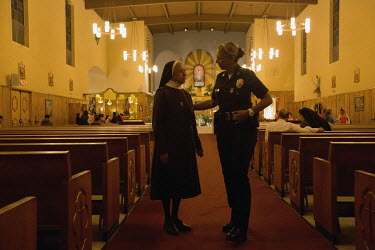 Ruby Flores, Police Captain at the Hollenbeck Community Police Station in Boyle Heights, speaks with Sister Rosa Gonzalez at the Resurection Church in Boyle Heights. She asked her officers to visit lo...