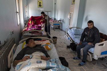 SDF fighters, injured in various battles during the fight against ISIS, recuperate at a military hospital.