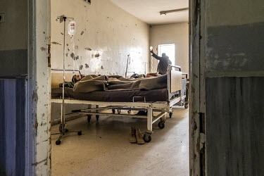 Injured soldiers, just arrived from the frontline 150km away, are treated in a ward in the decrepit Tudmur hospital, the only functioning hospital in the region.