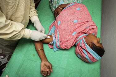 Medical staff give Rupeya Begum a contraceptive injection at the Health and Family Planning Centre.