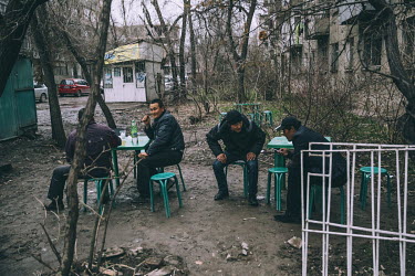 People drinking at an open air cafe.