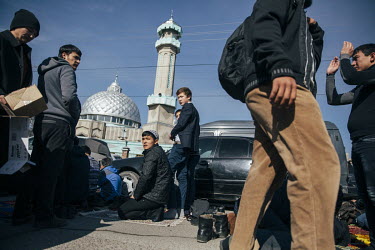 People gather for Friday prayers outside a mosque.