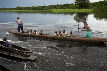 A group of children travel by canoe along the Itimbiri River, a tributary of the mighty Congo River.
