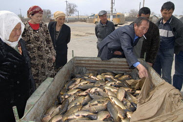 A man selling fresh fish that has been caught in a part of the north Aral Sea that has been restored. Moynaq was once a thriving fishing port on the sea shore but Soviet irrigation projects caused it...