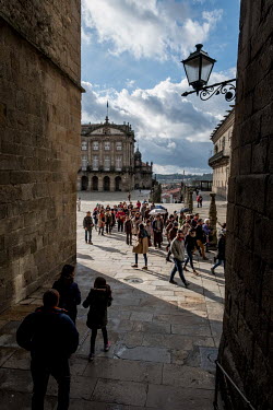 A large group of tourists visits the Praza do Obradoiro (Square of the Workshop).