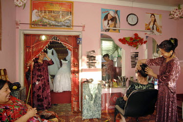 A woman has her hair styled at a hair and beauty salon.