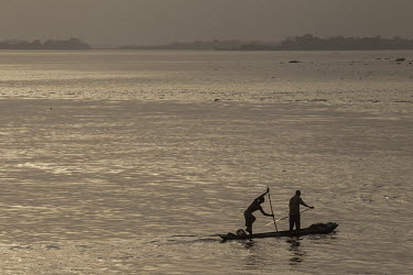 Two men paddle a canoe (pirogue) on the Congo River.