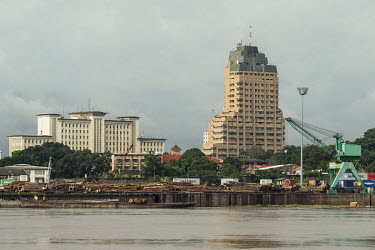 High rise buildings and a lumber yard on the banks of the Congo River.