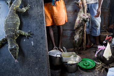 People selling bush meat on board a vessel operated by JCM Services travelling on the River Congo. The villagers from Makanza, the village that the vessel is passing, came aboard to sell a monitor liz...