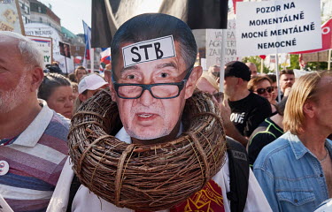 A man wearing a photo mask of premier Andrej Babis on his face and with a nest around his neck attends the biggest political protest since the fall of communism. About 120,000 people gathered in Wence...