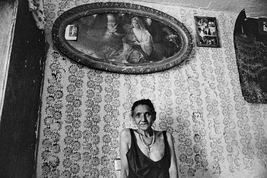 A portrait of an elderly Roma woman.