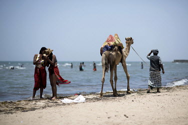 A Rashaida bedouin with camel walks along the seafront at the Gurgusum Beach Resort Hotel where many of the tourists are Eritreans who live overseas and have returned for a visit to their home country...