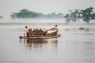 Two men paddle a canoe (pirogue) to one of the markets in Mbandaka to sell fruit, vegetables and bushmeat.
