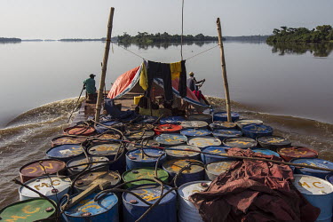 Steel drums lashed to the deck of a Congo River barge.