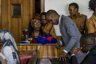 At the Buganda Road Chief Magistrate's Court Makerere University Researcher Dr. Stella Nyanzi talks to her lawyer, Isaac Ssemakadde, at the start of the the first of many hearings held to determine if...