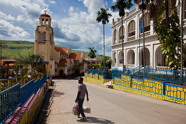 A man walks along a street in the former colonial-era city and port.