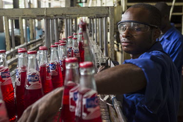 A worker sorts bottles in a Bralima factory where beers and soft drinks are produced. The facility, owned by Heineken, was closed due to its lack of profitability.