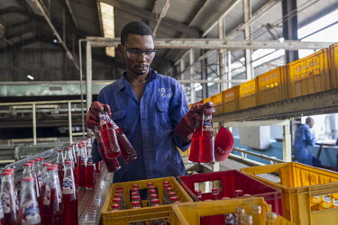 A worker sorts bottles in a Bralima factory where beers and soft drinks are produced. The facility, owned by Heineken, was closed due to its lack of profitability.