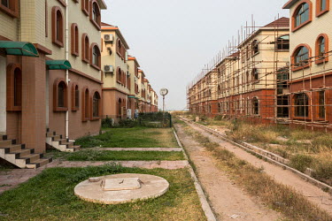 New apartment buildings under construction at the 'Cite du Fleuve' gated community. The development was built by a Chinese developer on an artificial peninsula in the Congo River. Most apartments are...
