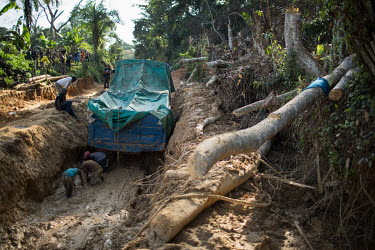 Workers try to dig out a truck stuck on a muddy road in Maniema province. Congo has notoriously bad roads that disintegrate when it rains.