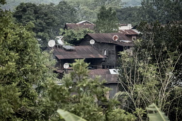 Satellite dishes and solar power panels adorn the roofs of houses in the village of Belambo which lies at the heart of the vanilla-growing region.
