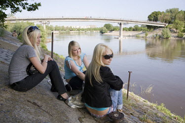 A group of young women sit beside the Dniestr River in Tiraspol, the capital of the breakaway republic of Transnistria, a predominantly Russian populated narrow strip of land on the eastbank of the Dn...