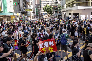 People, mostly dressed in black, walk from Victoria Park to Central during a mass demonstration against the extradition bill, police use of force during protests and to demand Chief Executive Carrie L...