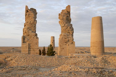 Sunset over Misrian, once a flourishing Silk Road oasis town of 80,000 people, destroyed by the Mongols in 1223. A part of the mosque entrance and two big minarets are all that is left of the city. Th...