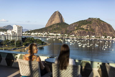 Guests at the Yoo2 hotel looking over Botafogo Bay towards Sugarloaf.