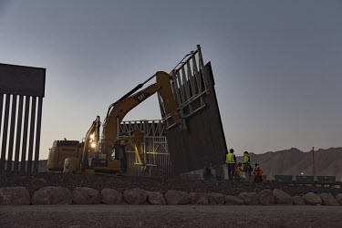 On a privately owned piece of land on the American side of the border, beside Ciudad de Juarez, a metal wall is being erected to stop illegal migration. The fence was privately funded by a group calle...