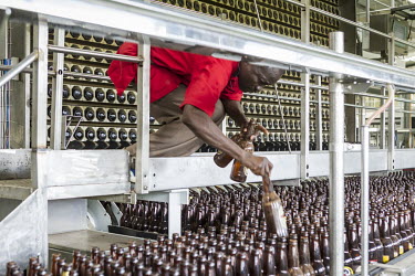 A worker cleans beer bottles in a Brasimba brewery. Brasimba, owned by the Castel company, opened the facility in 2012. It mainly produces Tembo and Simba brands of beer.