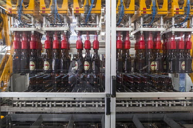 Bottles are filled with beer in an automated process at a Brasimba brewery. Brasimba, owned by the Castel company, opened the facility in 2012. It mainly produces Tembo and Simba brands of beer.