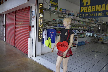 A female mannequin advertises Viagra outside a pharmacy.
