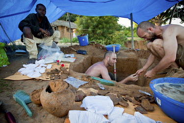 European archeologists examine pottery from a dig in a small village beside the Aruwimi River. The pottery they found is estimated to be 1,500 to 2,000 years old confirming theories about Bantu migrat...