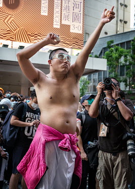 A demonstrator throws eggs as protestors besiege the head office of the Hong Kong police force during ongoing protests against the government's proposed extradition laws, police use of force during ea...