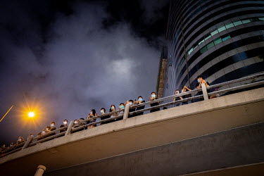 Demonstrators, using surgical masks to hide their identities, besiege the head office of the Hong Kong police force during ongoing protests against the government's proposed extradition laws, police u...