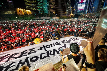 People hold up signs with the slogan: 'Free Hong Kong, Democracy Now!' during ongoing protests against the government's proposed extradition laws, police use of force during earlier protests and also...