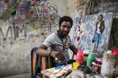 Contemporary painter JP Mika at work in his studio in Kinshasa.
