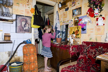 A girl combs her hair in a decrepit flat in the ghost town of Sirgala. During the Soviet-era Sirgala was a flourishing mining town, inhabited by Russian workers. With the decrease in oil shale mining...