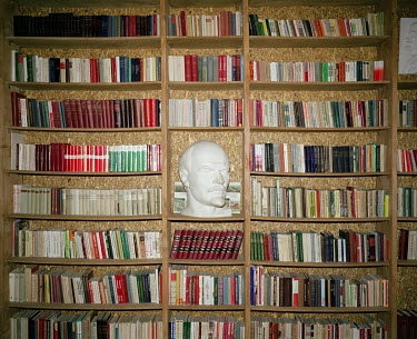 A scupltured Lenin head and communist books in Grutas Park. The sculpture garden of Soviet-era statues and displays of other ideological relics, was founded by the Lithuanian entrepreneur Viliumas Mal...