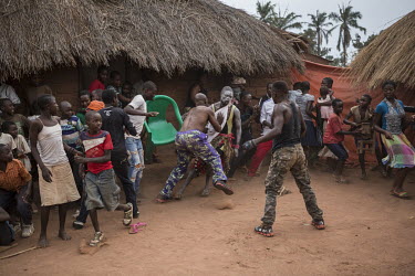 The crowd scatters as the action kicks off outside the ring during a wrestling show put on by a troupe of travelling fighters who go from village to village entertaining the residents. They stay in ea...