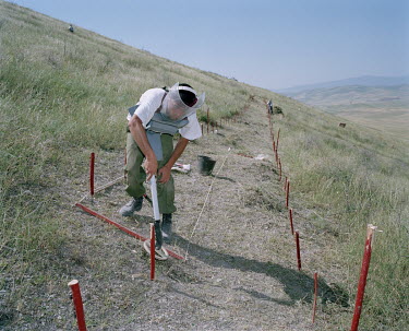 A deminer working for the Halo Trust uses a detector to locate anti-personnel mines buried in the Martuni 9 minefield. During the war between Armenia and Azerbaijan (1988 - 1994) both countries deploy...
